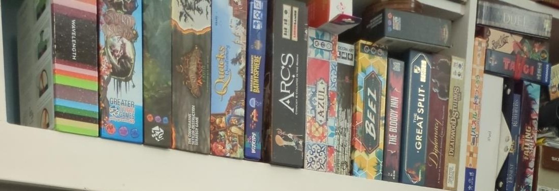 [Photo of part of a shelf with game boxes]